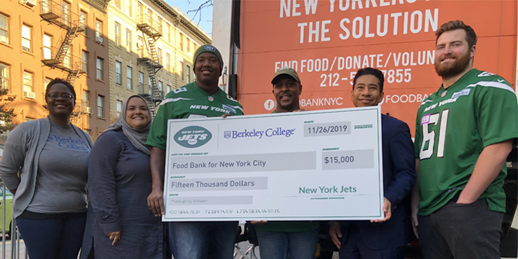 Berkeley College and the New York Jets presenting large check of $15,000 to the Food Bank of NYC