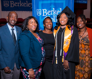 Photo of Berkeley College graduate at Commencement with family. mobile image