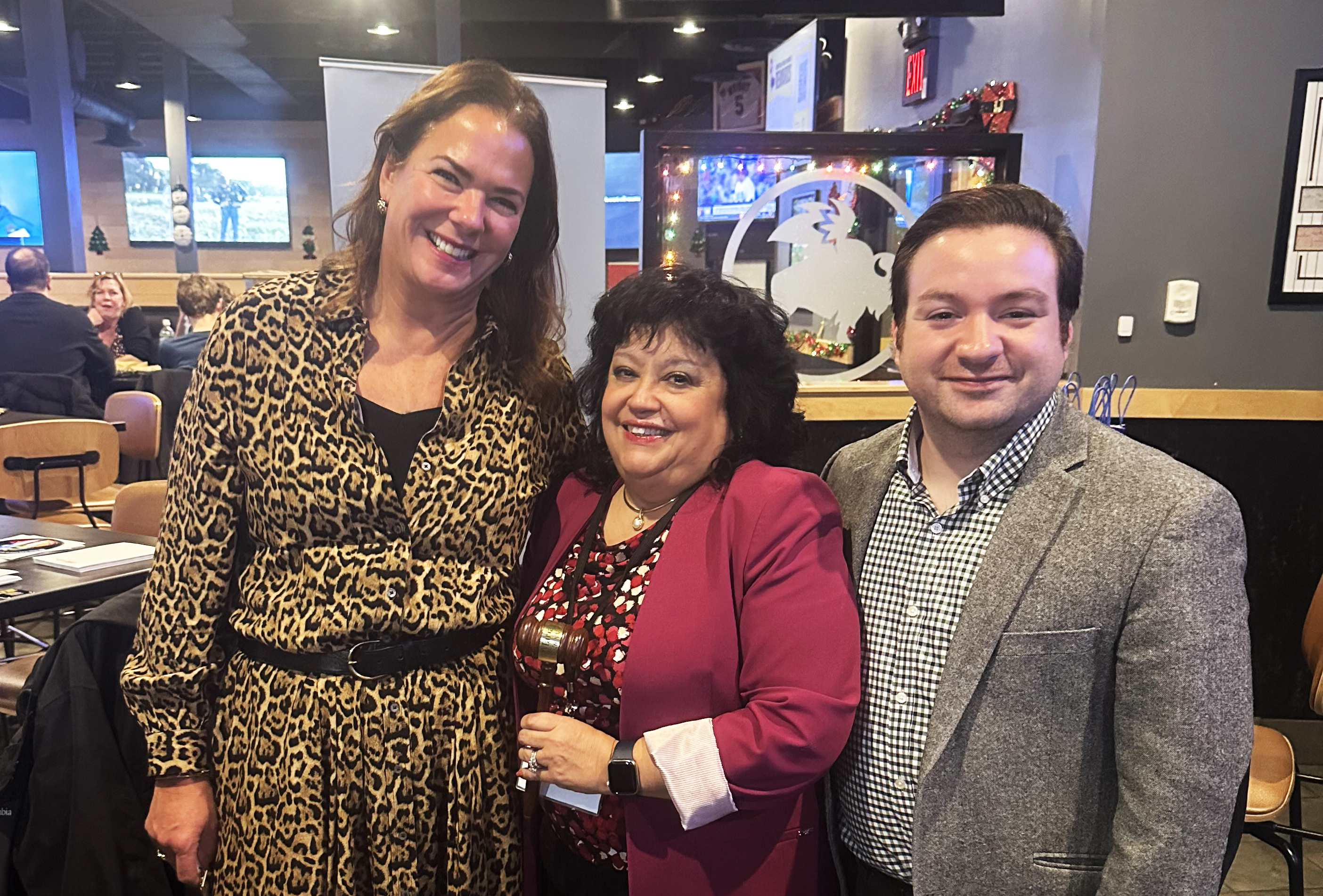 Officials smile at a restaurant