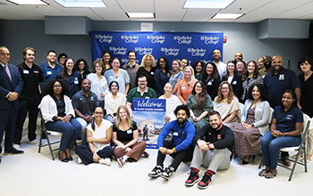 Group photo of NJ Transfer Counselor Association members posing with a “Welcome” sign in front of a Berkeley College backdrop.