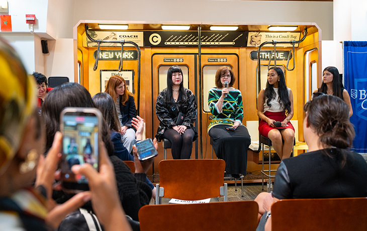 Panel discussion with four women seated inside a vintage New York subway car as an audience records the event.