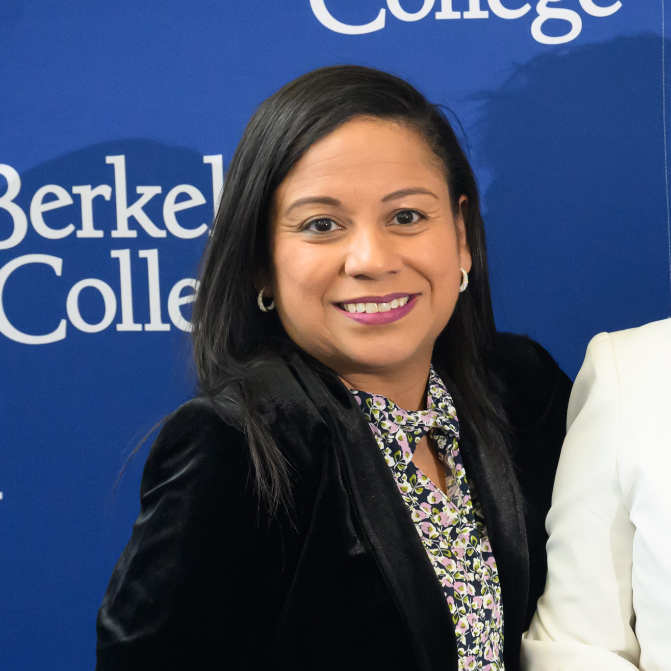 A woman with dark hair smiles