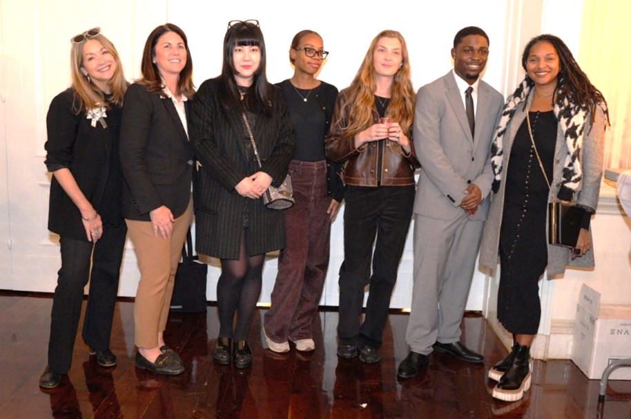 A group of diverse people smile and poses for the camera