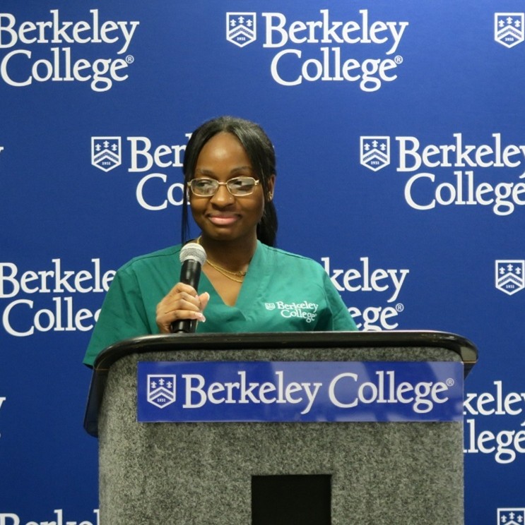 A student stands at a podium giving a speech