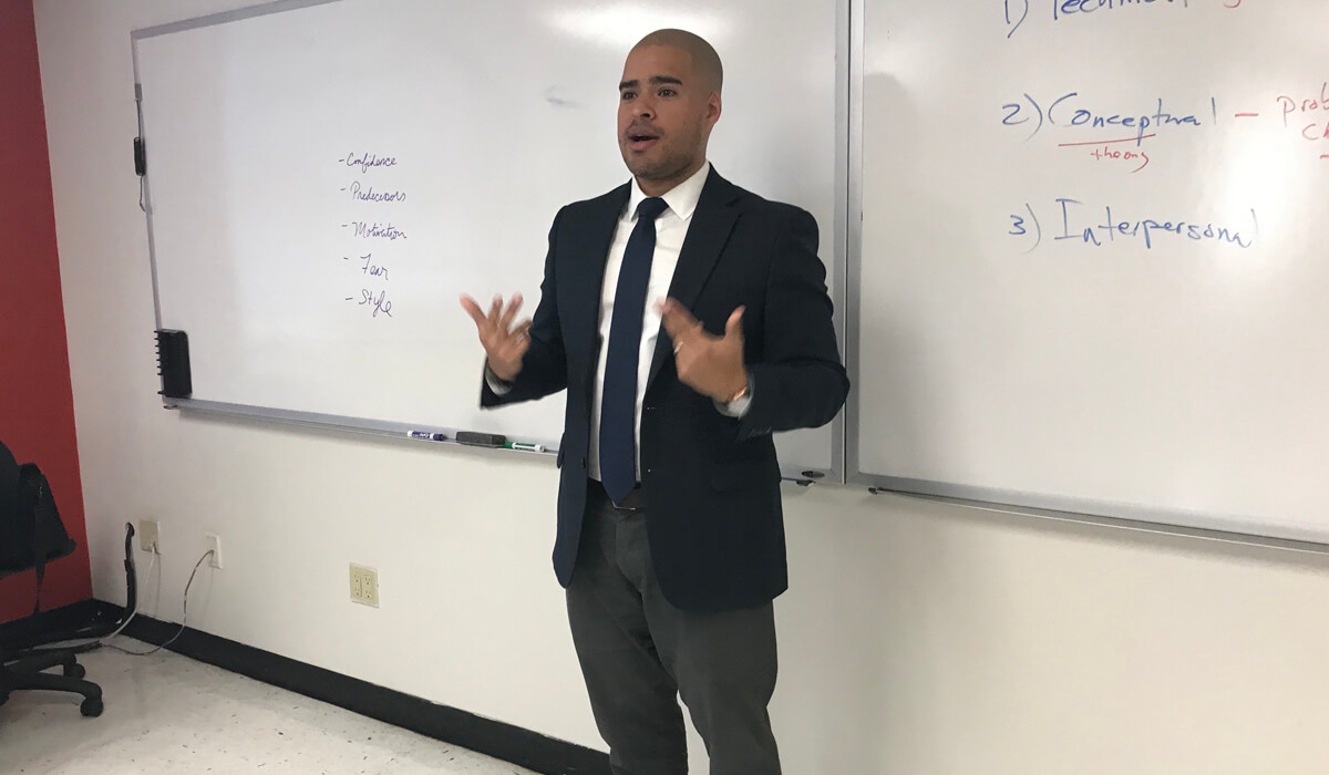 Ramon Taveras Standing in Front of Classroom Speaking