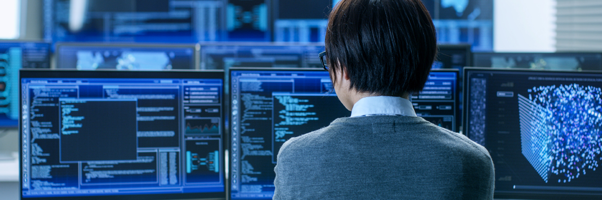 Image of a person working on a computer at a command center