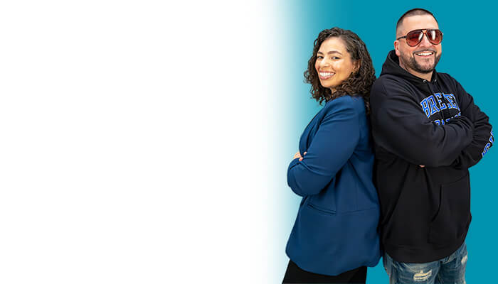 A smiling man and woman stand together, exuding warmth and positivity.