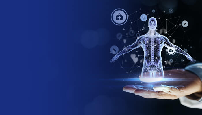 Digital hologram of a human body hovering over a hand, surrounded by medical icons on a blue background representing telehealth technology