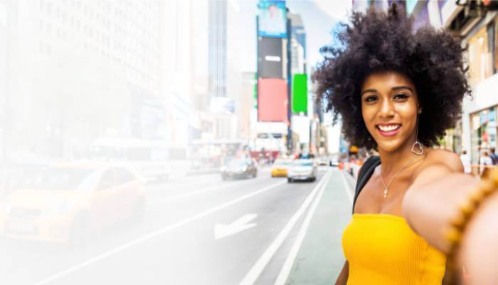 Student exploring New York City during a summer fashion experience program, with Times Square in the background