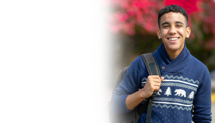 Student smiling during Berkeley College Open House event, welcoming future students on campus.