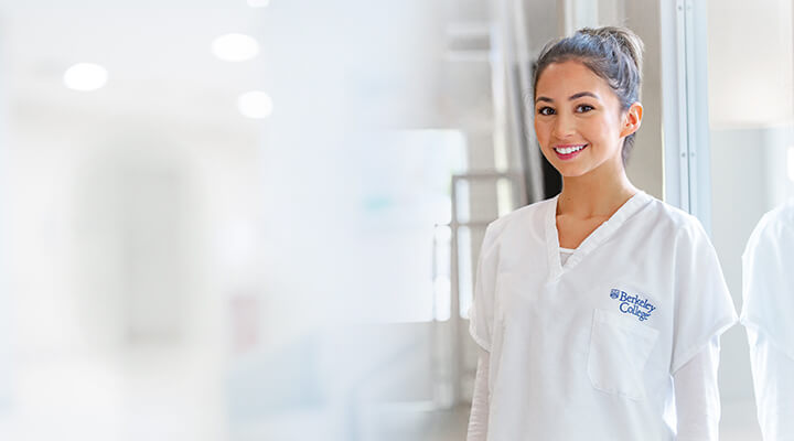 A friendly female doctor smiles in a hospital room