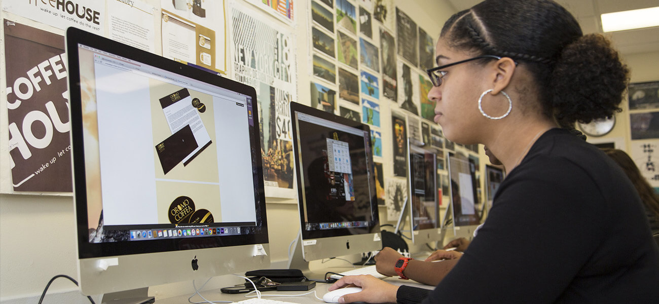 berkeley student in front to a computer