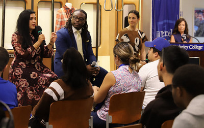 A diverse group of individuals seated in chairs, engaged in conversation and sharing ideas in a relaxed setting