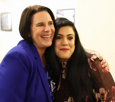 Image of Diane Recinos and a student sharing an moment of joy together