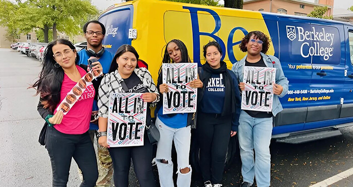 Several people gather in front of a van, each holding signs that express their thoughts and opinions