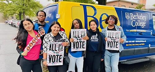 Several people gather in front of a van, each holding signs that express their thoughts and opinions