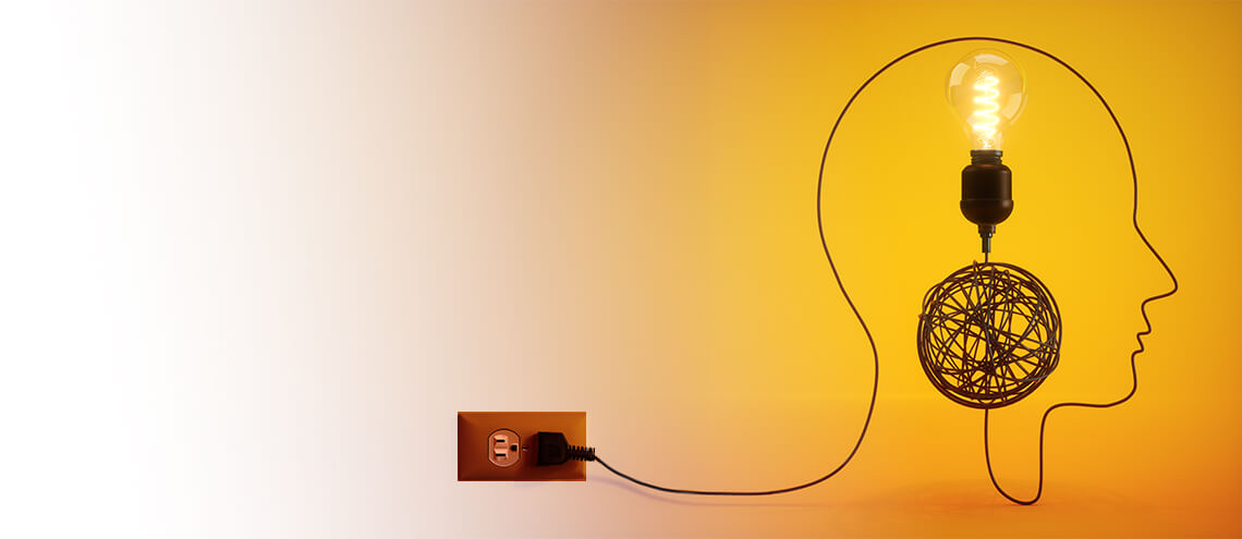 A light bulb atop a silhouette of a head, connected by a wire to a tangled ball, symbolizing creativity and ideas on an orange background.