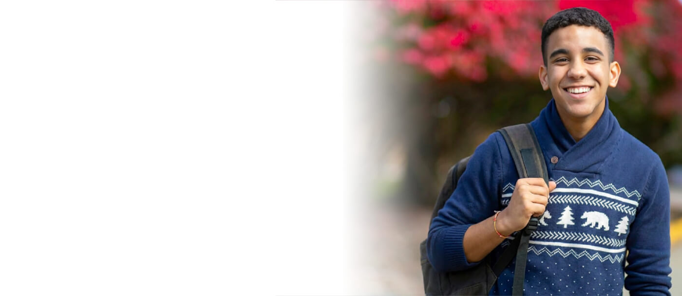 Student smiling during Berkeley College Open House event, welcoming future students on campus.