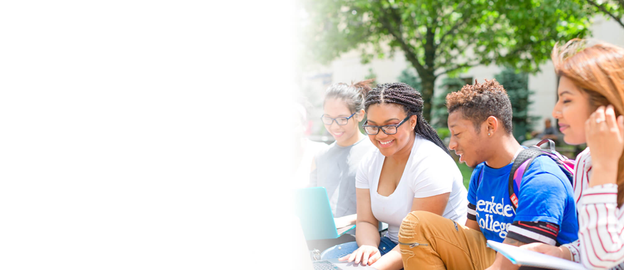 Image: Photo of Berkeley College students on a laptop outdoors.