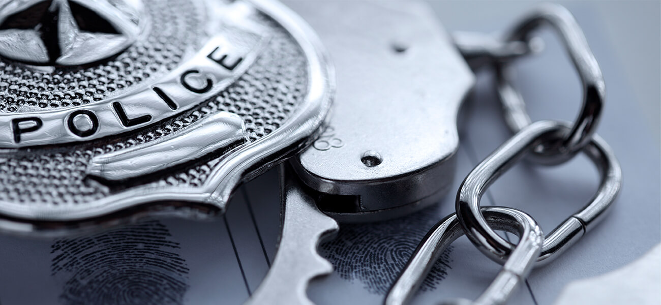 image of police badge and handcuffs
