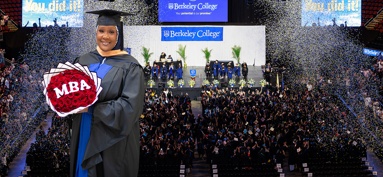 Berkeley College MBA graduate Quaasia McCrary smiling in a cap and gown, holding a bouquet of red roses spelling MBA against a background of a commencement ceremony with falling confetti