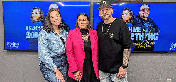 Three people standing in front of a blue Teach Me Something podcast screen with Berkeley College and iHeart logos