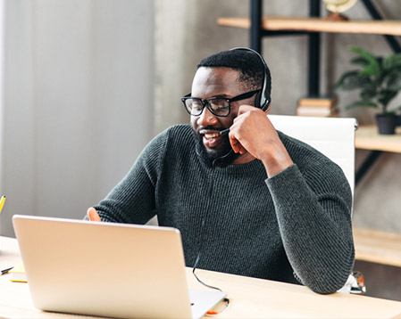 image of a man in front of a laptop