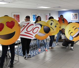 Students with emoji cut outs at New Student Orientation mobile image