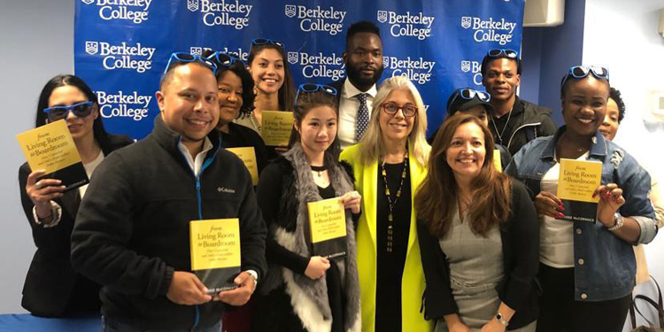 Corinne McCormack and group of students at Fashion event holding books