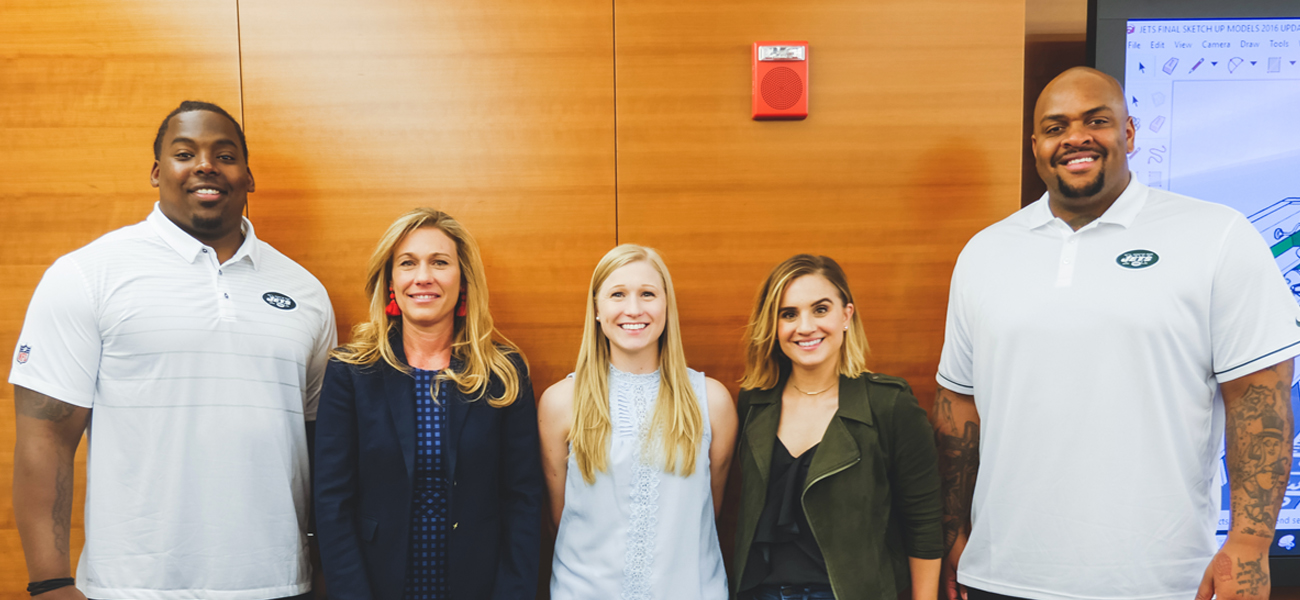 Interior Design team with Jets players at Jets facility