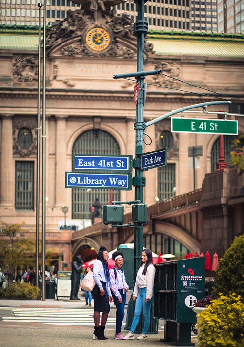 A diverse group of individuals gathered at in front of the Grand Central Terminal in New York City