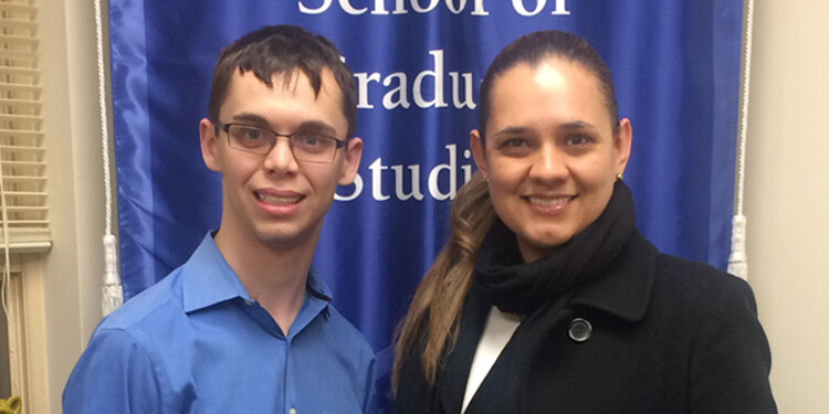 Male and female student in front of Berkeley College banner