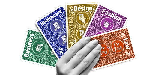 Hand holding five colorful career cards for Fashion, Business, Justice, Healthcare, and Design workshops