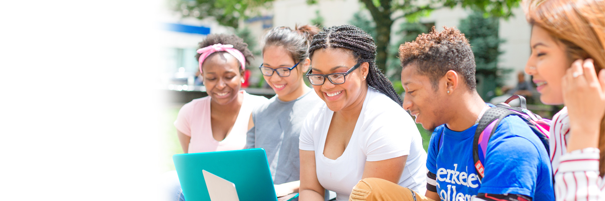 Photo of Berkeley College students on a laptop outdoors.