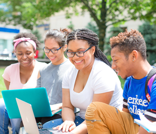 Photo of Berkeley College students on a laptop outdoors. mobile image