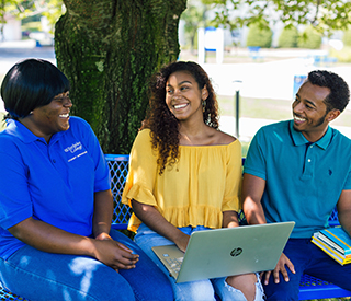Photo of the 3 Berkeley College at Woodland Park Campus sitting on a bench under a tree mobile image