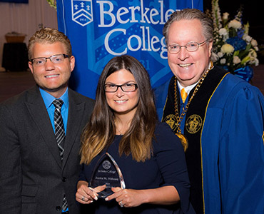 Photo of Jessica Mahoney, Esq., receiving the 2018 Alumni of the Year award with Michael Iris and Berkeley College President Michael Smith.