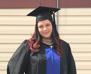 Photo of Ruth Shaver wearing her cap and gown.