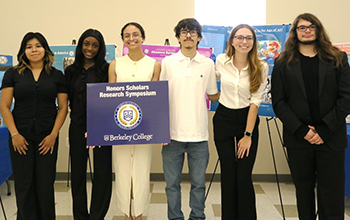 A group of students stands and smiles at the camera.