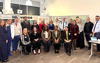 A group of people smile and pose for the camera.