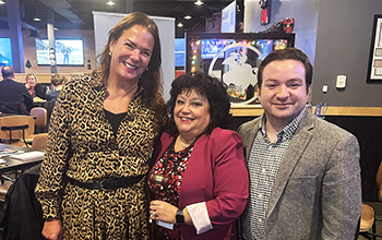 Berkeley three people smile in front of a mirror