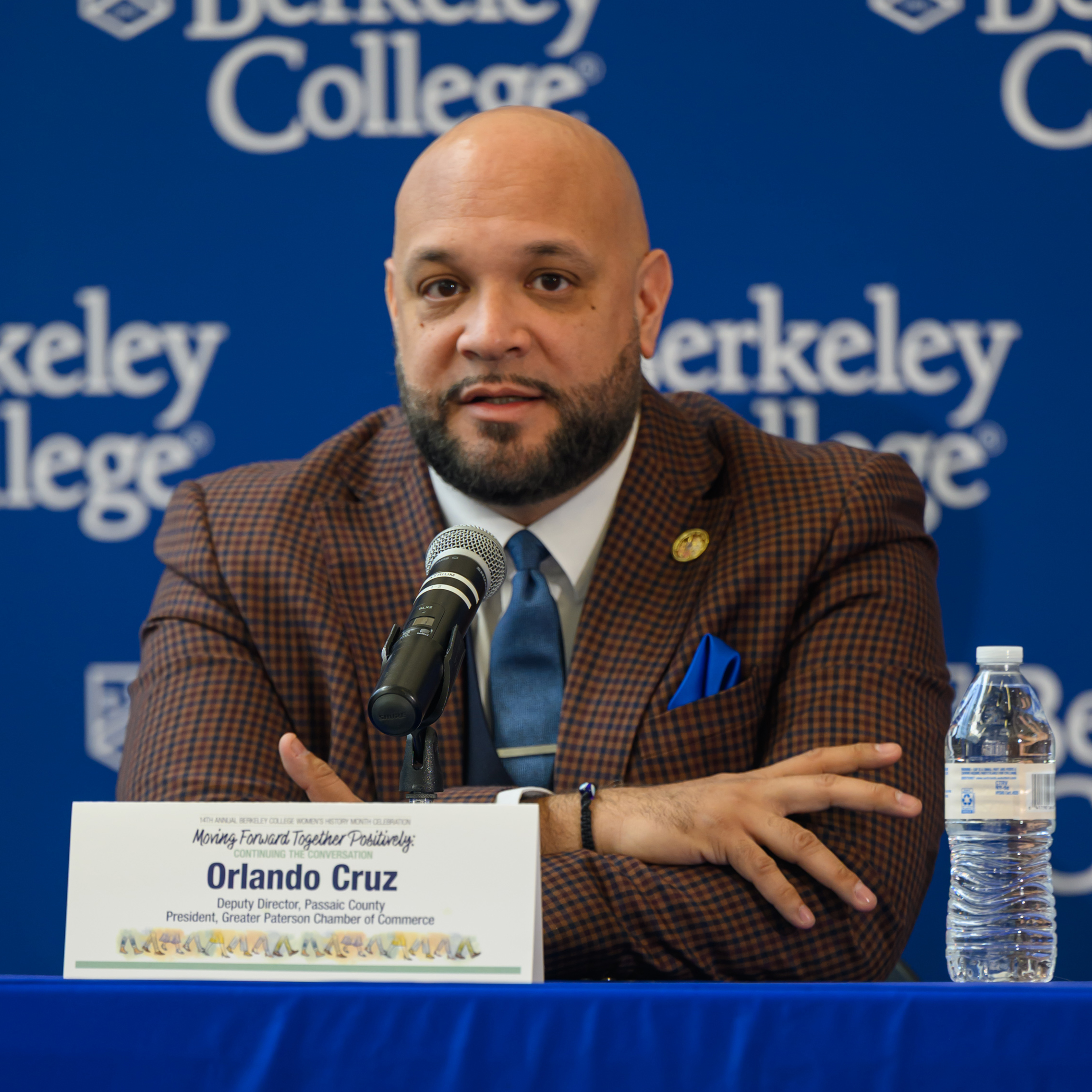 A man with a beard crosses his arms