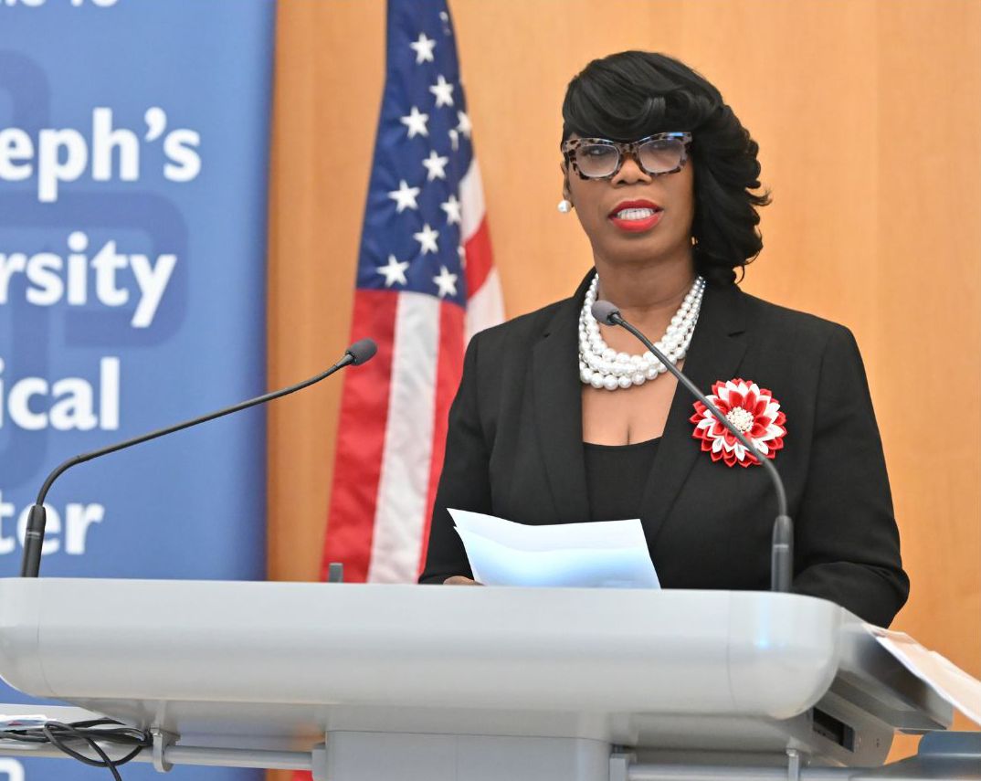 A woman speaks at a podium