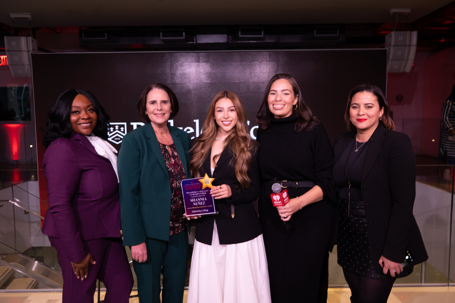 A group of women holding an award
