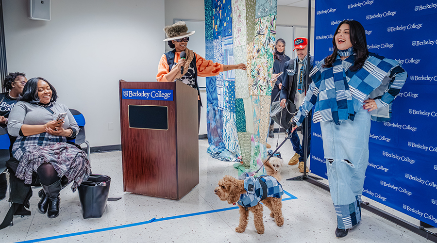 a woman stands with a dog in matching outfits