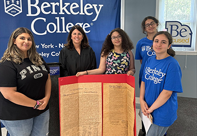 Students and professors hold a sign