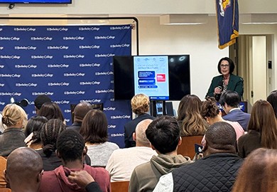 a woman at a podium speaks to an audience