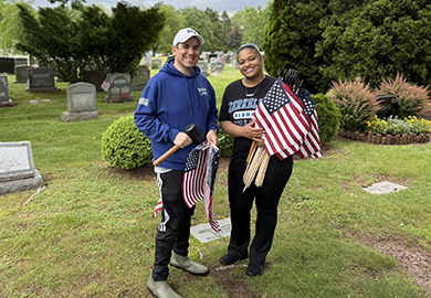 a man and a woman hold american flags