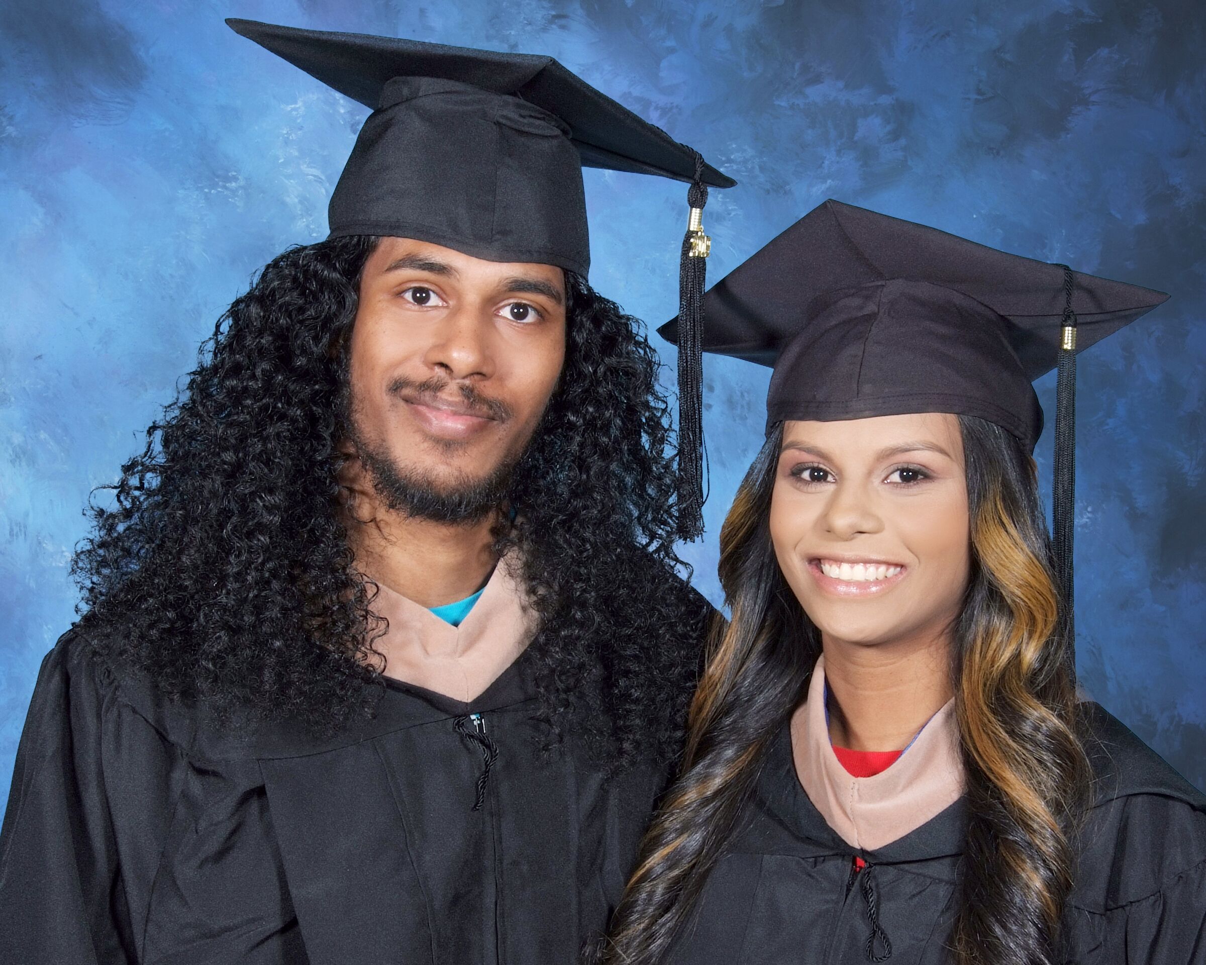 Rajiv and Najeree Wallace in cap and gown