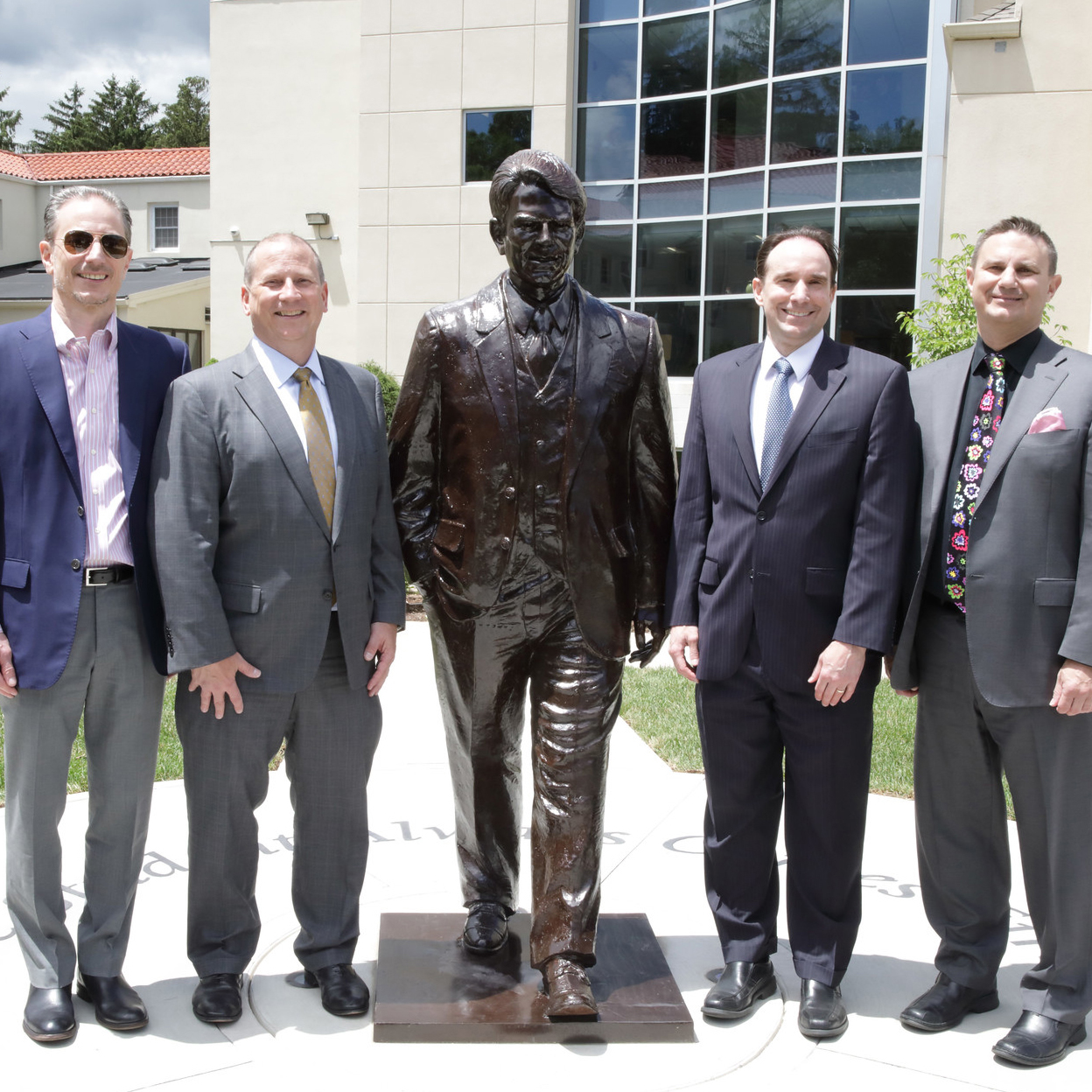 The Luing brothers stand by the statue of Larry L. Luing